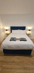 a bed with two robes on it in a bedroom at Sullane Weirs in Macroom