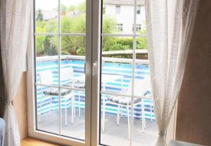 a window with a view of a swimming pool at FeWo-Seestrasse in Diemelsee