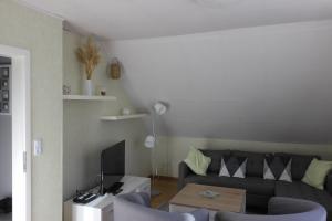 a living room with a couch and a table at FeWo-Seestrasse in Diemelsee