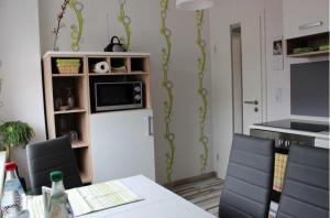 a kitchen with a white refrigerator with a microwave at FeWo-Seestrasse in Diemelsee
