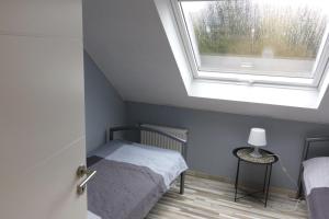 a bedroom with a bed and a window at FeWo-Seestrasse in Diemelsee +21 photos