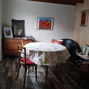 a room with a table and chairs and a mirror at Tour Rose in Frangy