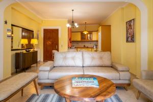 a living room with a couch and a table at Aurora Apartment in Afitos