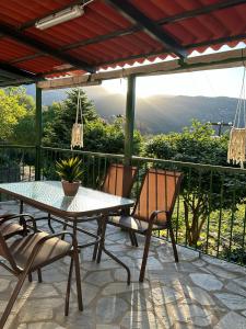 a table and chairs on a patio with a view at SO SIMPLE mouresi in Mouresi