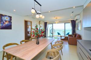 a kitchen and dining room with a table and chairs at The Sóng Vung Tau Apartment - Pool Near Sea in Vung Tau +116 photos