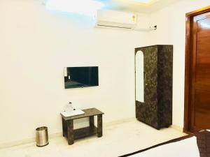 a bathroom with a table and a mirror on the wall at HoTEL K7 in Chennai