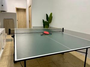 a ping pong table with a ping paddle on it at Los Henares 3 in Olombrada
