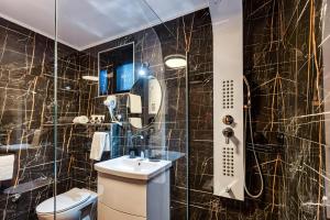 a bathroom with a toilet and a sink and a mirror at Apartmani Tiske noći in Bečej +128 photos