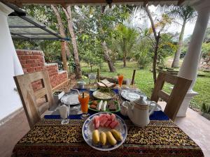 a table with plates of food on top of it at Sigiriya Lantern Homestay in Sigiriya