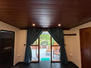 a room with a door open to a patio at Sigiriya Lantern Homestay in Sigiriya