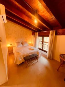 a bedroom with a large bed and a large window at Casa Kirana - Habitaciones in Bermeo