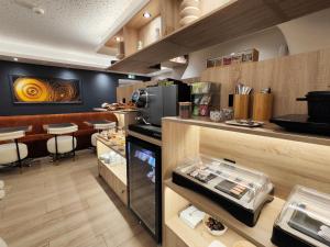 a restaurant with a counter and a restaurantasteryasteryasteryasteryasteryasteryasteryastery at 55 Hôtel Montparnasse in Paris