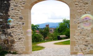 an archway leading to a path in a park at Le Havre Familial - 5 couchages climatisé in Romans-sur-Isère