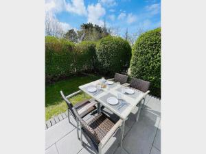 a table and chairs sitting on a patio at Apartment Pangani Teichhof Fehmarn in Wenkendorf