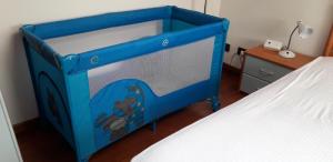 a blue bed in a room with a white bed at Casa Vacanze Da Ile 2 in Malborghetto Valbruna
