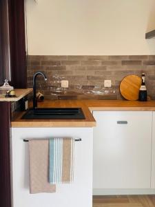 a kitchen with a sink and a counter top at Parus major in Londerzeel