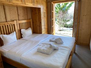 a bedroom with a large bed with towels on it at Chalet Rosablanche in Veysonnaz