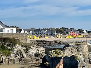 a view of a town with a stone wall and houses at Constance de Bretagne B&B in Batz-sur-Mer