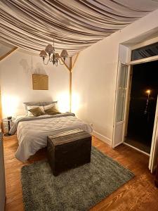 a bedroom with a bed with a large window at Le Clair-Obscur in Paray-le-Monial