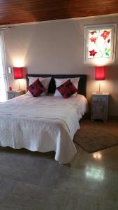 a bedroom with a bed with two pillows and a window at Villa Solary in Le Pontet +53 photos