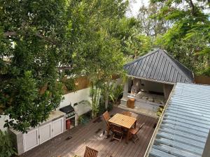 an overhead view of a wooden deck with a table and chairs at Lakaz feuillaze in Port Mathurin