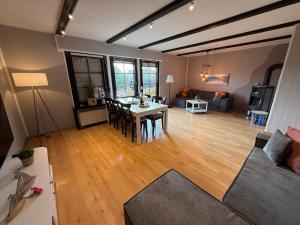 a living room with a table and a couch at Strandgut- unsere Große in Dranske +29 photos