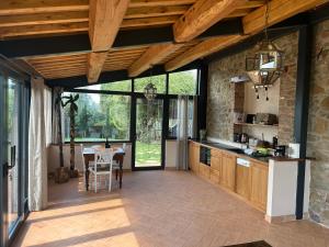 an open kitchen with a table and a dining room at Fontanaro Farm and Culinary School in Paciano
