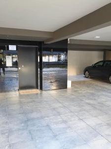 a garage with a car parked in a parking lot at Elario studio in Larisa