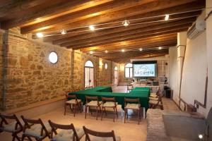 a conference room with a green table and chairs at La Cianella - Adult Only in Scarlino
