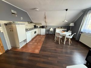 a kitchen and dining room with a table and chairs at Strandgut- unsere Kleine in Dranske