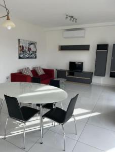 a dining room with a white table and chairs at Park Lane Experience Apartments in Il-Gżira
