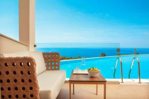 a living room with a couch and a table at Zeus Eleva Ajul in Agia Paraskevi