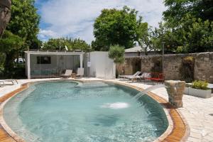 a swimming pool with a fountain in a yard at Procida Camp & Resort - La Caravella in Procida