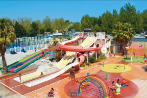 a water park with a slide at a playground at Mobile home 8 personnes in Sérignan +13 photos