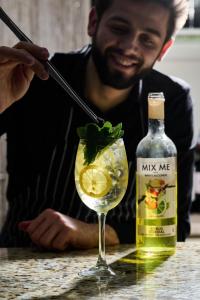 a man is stirring a drink in a glass at Eurohotel in Lviv +65 photos
