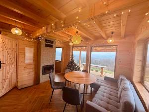 a living room with a couch and a table at Slow Mountains in Wola Piskulina