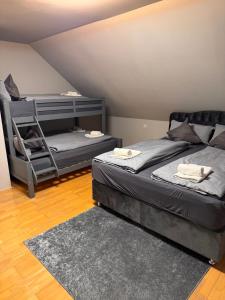 a room with two beds and a chair in it at Villa Altdorf in Ettenheim