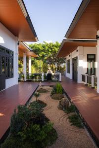 a person sitting on the porch of a house at Chevana Resort in Ban Doi Yao