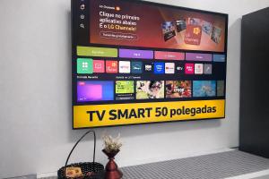 a television hanging on a wall with a tv smart packages at Studio Romã térreo com cozinha in Curitiba