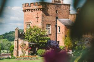 an old brick castle with flowers in front of it at The Citadel in Weston