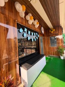 a room with a pool table and a green floor at Hotel Glitter in Guwahati