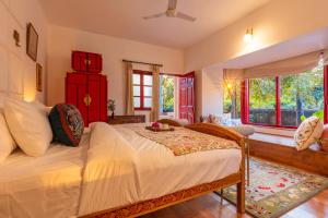 a bedroom with a bed and a large window at Seclude Hampi 1800 in Sandūr +110 photos