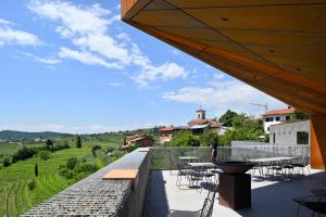 a patio with tables and chairs and a view of a field at Villa Alma Vista in Dobrovo