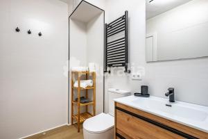a bathroom with a sink and a toilet and a mirror at QUINTA PORTIELLO Ribadesella in Ribadesella +9 photos