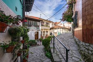 an alley in an old town with potted plants at QUINTA PORTIELLO Ribadesella in Ribadesella