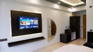 a flat screen tv on a wall in a room at lucknowi stay in Lucknow