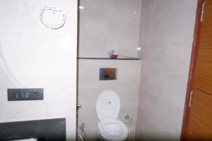 a bathroom with a toilet with the lid up at lucknowi stay in Lucknow