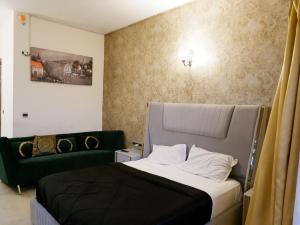 a bedroom with a bed and a couch at lucknowi stay in Lucknow