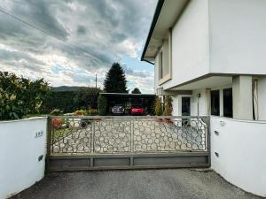 a house with a gate in front of a driveway at Relax in Lucca - Private Swimming Pool in Lucca