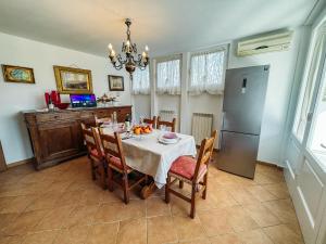 a dining room with a table and a refrigerator at Relax in Lucca - Private Swimming Pool in Lucca
